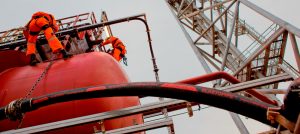 Underneath view of man working on offshore site with Elastopipe fire